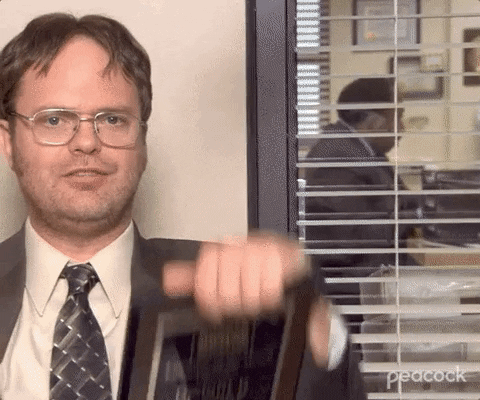 Dwight Schrute Holding Up Two Employee Awards Plaques