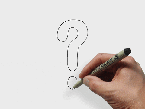 A question mark being hand drawn on a paper