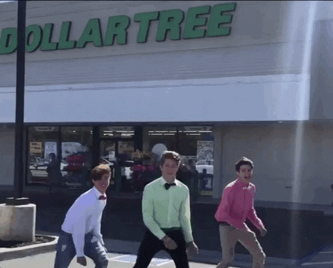 Three boys dancing in front of Dollar store