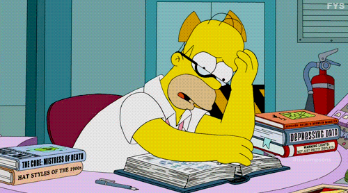 Homer Simpson worriedly flipping through pages of a book