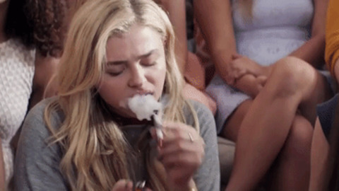 Chloë Moretz smoking a cigarette (or weed)
