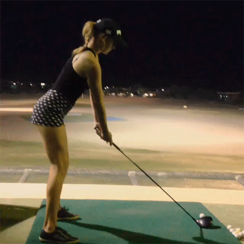 fit woman perfectly swung her golf stick and hit the ball
