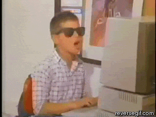 cool kid at computer puts on glasses