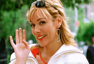 Samantha Jones from Sex and The City giving a friendly wave animated GIF.