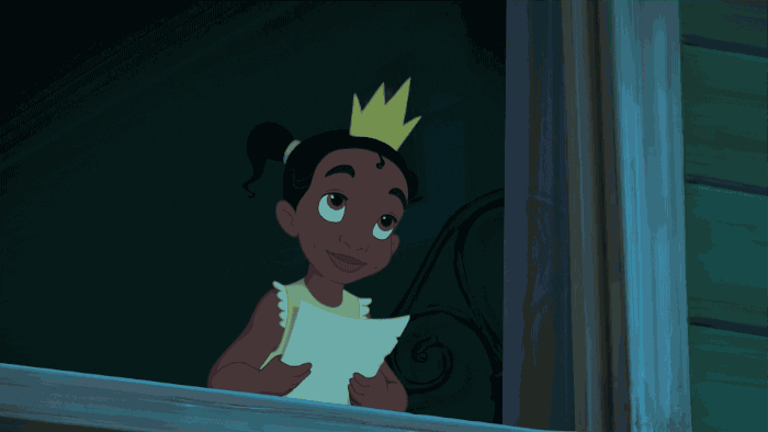 A child wearing a crown in the window and hugging a pillow