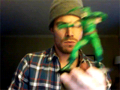 Stephen Amell playing with a Green Arrow toy