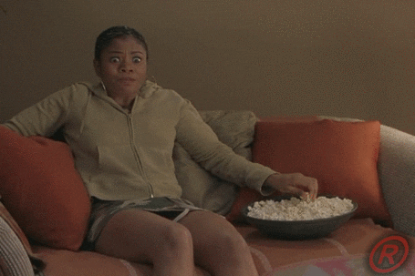 scary movie actress regina hall eating popcorn and looking scared
