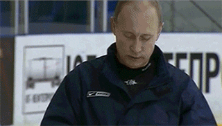 Putin puts on a helmet while on the ice. Putin puts on a helmet while on the ice.