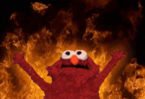 Sesame Street: Elmo raises both arms in front of a wall of flames.