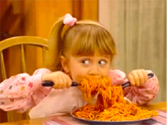 GIF of Michelle Tanner (Mary Kate or Ashley Olson) shoveling pasta into her mouth on "Full House"