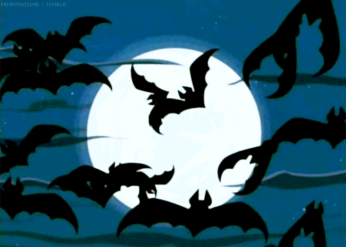 A flock of bats flying across a full moon