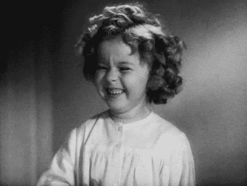 Shirley Temple laughing and smiling