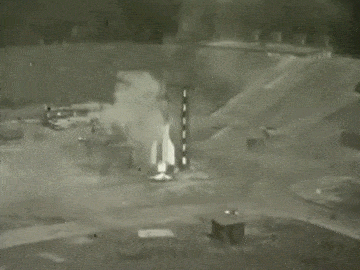 A rocket attempts to launch, but topples over and explodes.