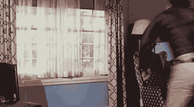 Gif of a man running through and shattering a window.