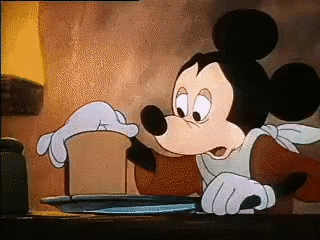 Mickey Mouse cuts a very thin slice of bread and serves it on a plate to Goofy. The slice of bread flutters down like a leaf until it hits the plate.