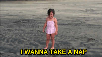 Little girl crying on the beach with the caption "I wanna take a nap"