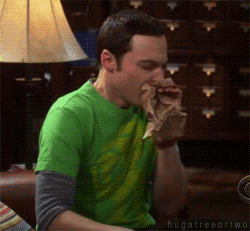 Sheldon hyperventilating into a brown paper bag