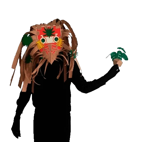 Figure in a fringed cardboard mask holding out a small green plant