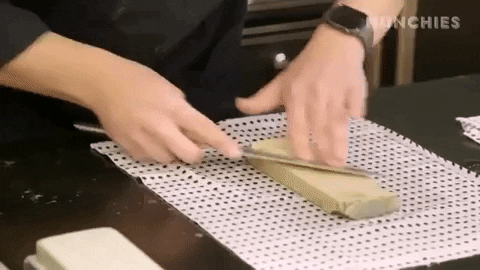 a chef sharpening a kitchen knife