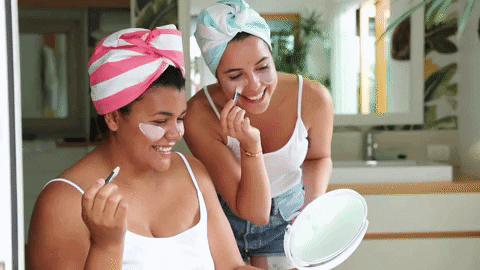 a GIF of two girls doing clay masks
