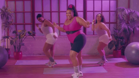 Giphy of Lizzo dancing in a workout studio with two other women