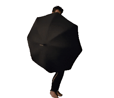Klaus (Robert Sheehan) dancing around with an umbrella