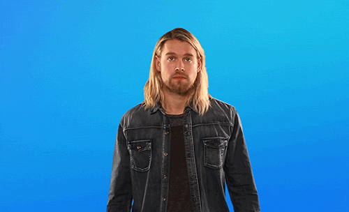 a man with long hair and a denim jacket