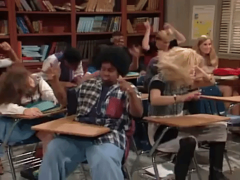 Gif of students sitting at desks and dancing