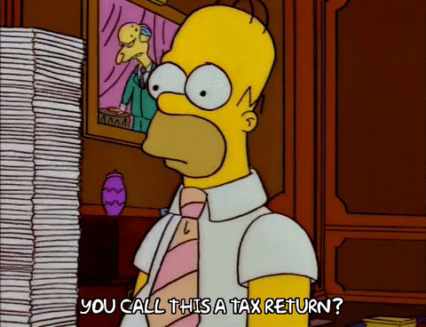 Homer Simpson handing Mr Burns a tax return and the papers being pushed off the desk
