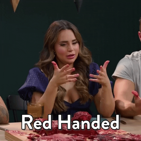 GIF of woman with blood on hands saying "red handed"