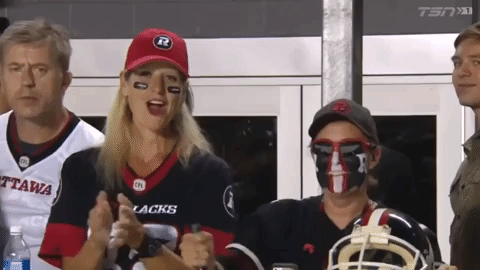 female fan cheering for ottawa redblacks