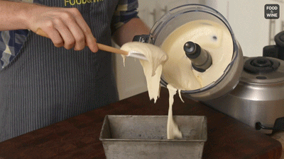 person putting a home made ice cream from blender to a container