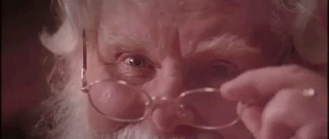 Papai Noel puxando o óculos e piscando um olho