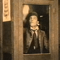 Buster Keaton cleans a window and then leans through it.