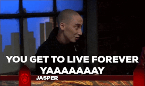 Man on a talk show set, captioned 'You get to live forever, yaaaaay'