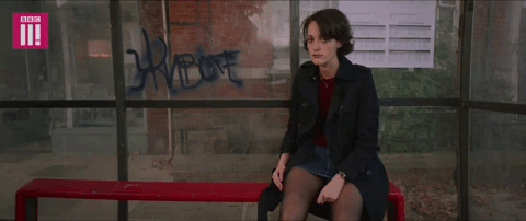 fleabag sitting at a bus stop and putting her head in her hands