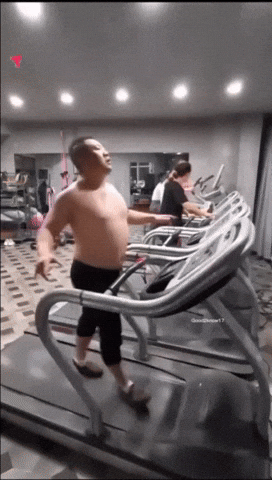 Guy struggling on treadmill—tough grind.