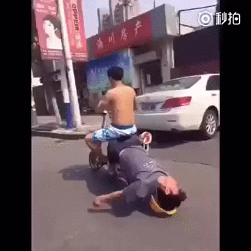 gif of drunk man leaning off back of scooter with head resting on hat 