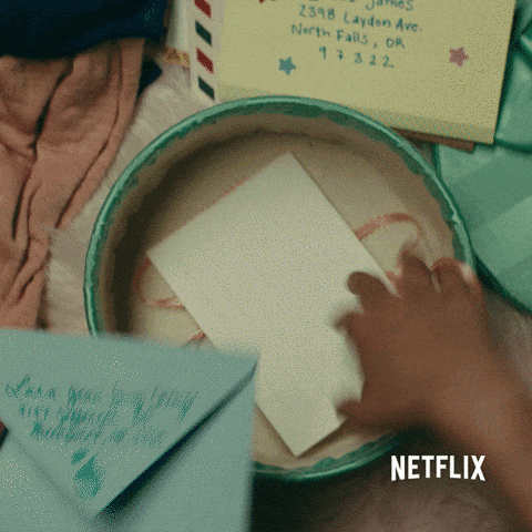(A person places many love notes into a box and then hides the box under a blanket) Via Giphy 