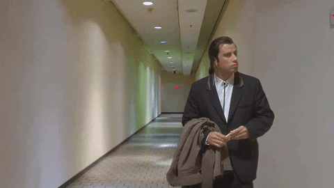 Man wearing a suit is lost in a hallway.