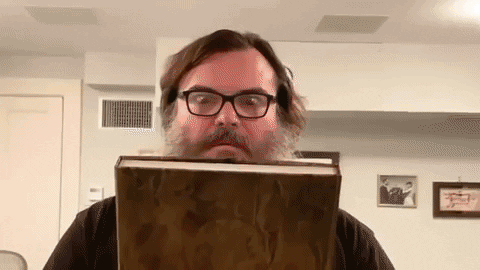 Jack Black opening a book that shines