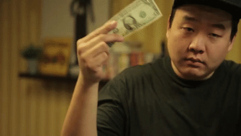GIF where a guy dances with a dollar bill