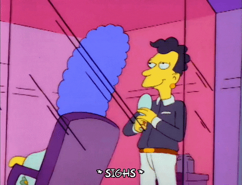 a GIF of Marge Simpson at a hair salon with her stylist sighing at the sight of her hair