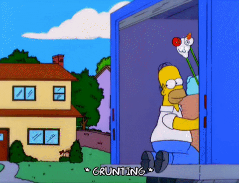 Homer Simpson tripping out of moving truck with large cardboard box, tumbling over