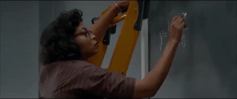 Hidden Figures actress solving an equation on a blackboard