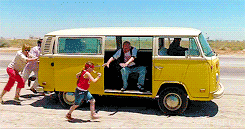 Scene from little miss sunshine with the family pushing a yellow van as the grandfather picks up the little girl