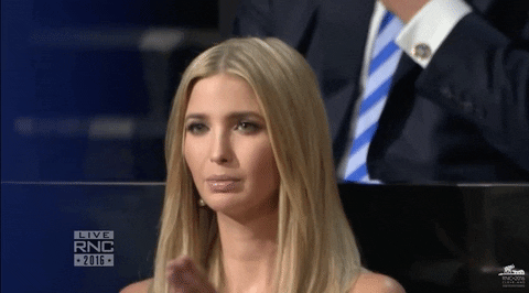 Ivanka Trump clapping her hands and blinking.