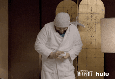 Gif of man wearing comfortable white dressing gown