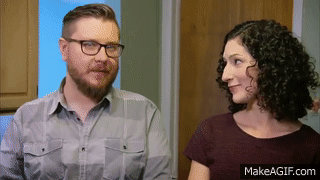 A couple speaks to each other during an interview.
