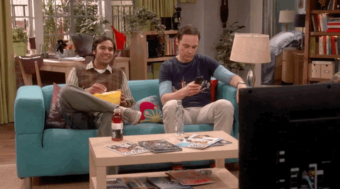 Gif of a scene from the TV show "Big Bang Theory" of two characters watching TV
